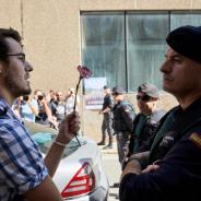 Man with carnation facing a civil guard (Marc Castellet)